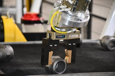 SCHUNK gripper on a FANUC robot picking a cast bung part