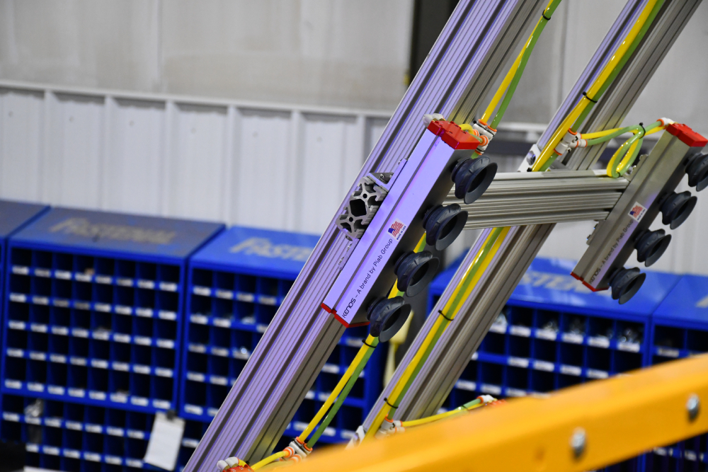 Vacuum end-of-arm tool used to unload fiberglass door skins from the press
