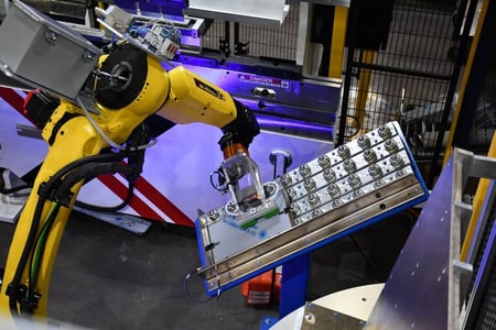 FANUC M-10iD/12 robot placing a blank on the positioning table in front of the press brake